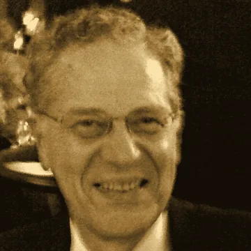 Portret Joe Taylora K1JT, uśmiechnięty, w okularach, tonowany na sepię