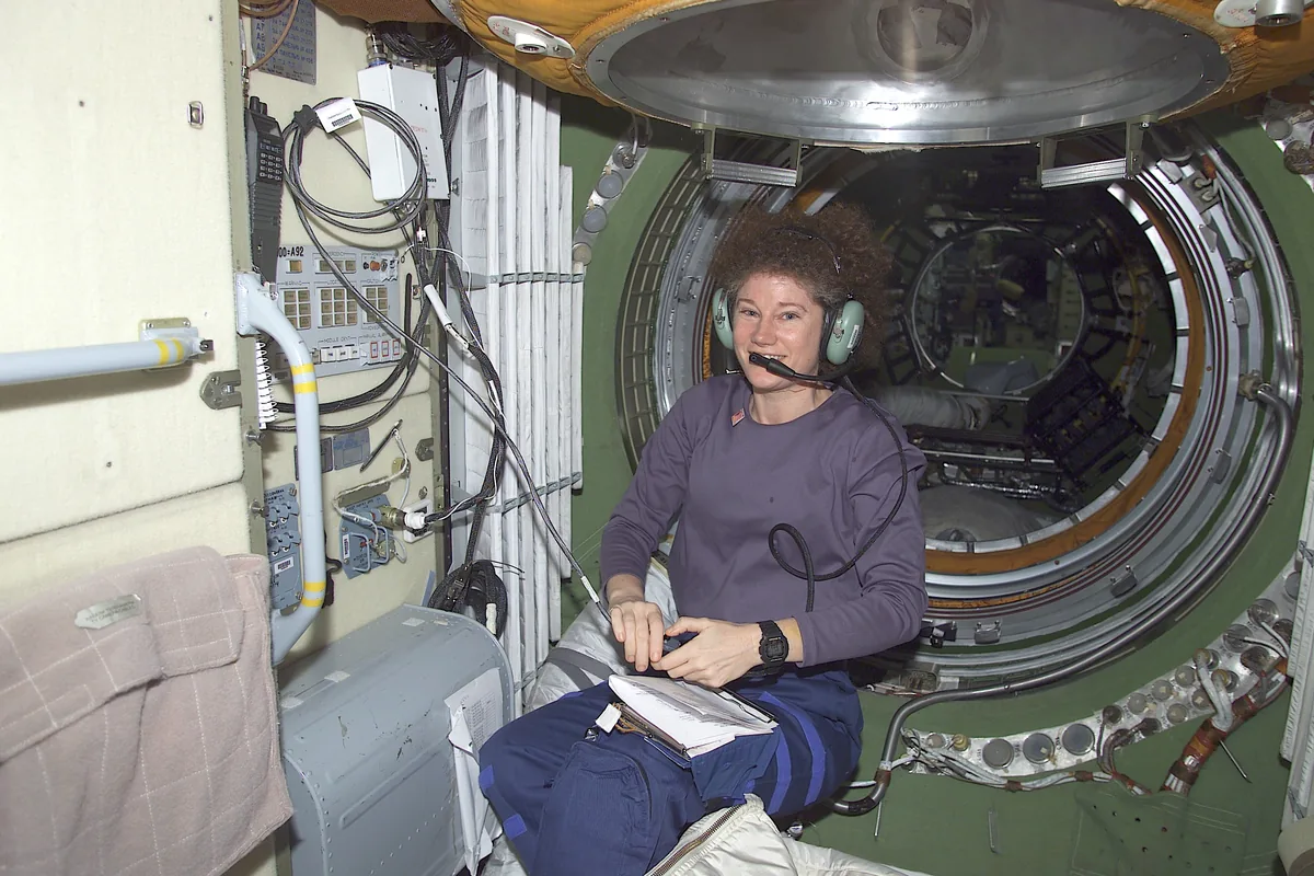 Astronautka Susan Helms w słuchawkach przy stacji radioamatorskiej w module Zaria na ISS